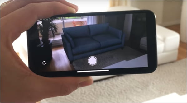 camera showing augmented reality picture of a couch.